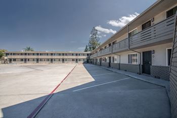 a parking lot with a building in the background